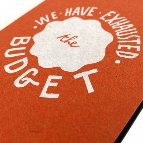 Notes tascabile "We have exhausted the budget", copertina arancione e interno in carta colore nero